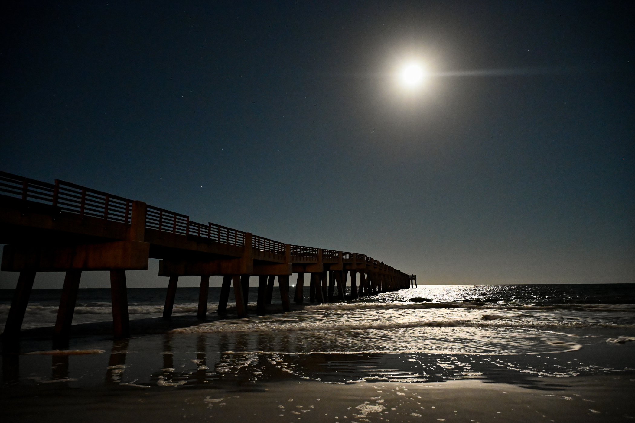The Jacksonville Beach pier under a bright beaver moon.